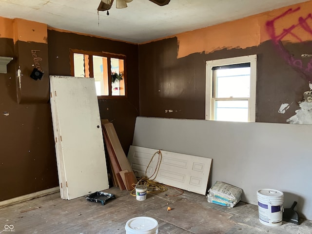 interior space with ceiling fan