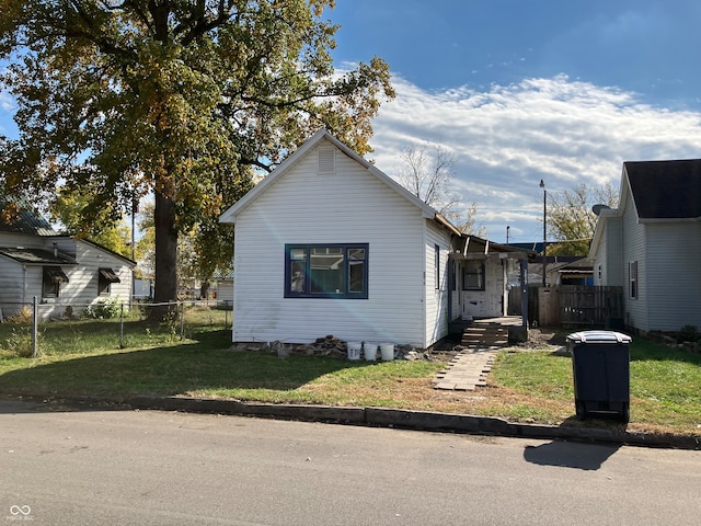 bungalow-style home featuring a front yard