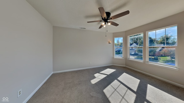 spare room with carpet floors and ceiling fan