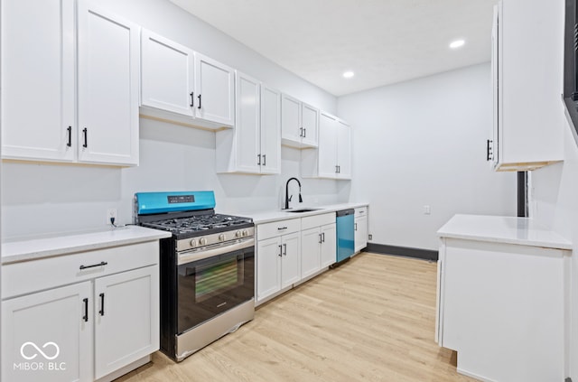 kitchen with white cabinetry, stainless steel appliances, and light wood-type flooring