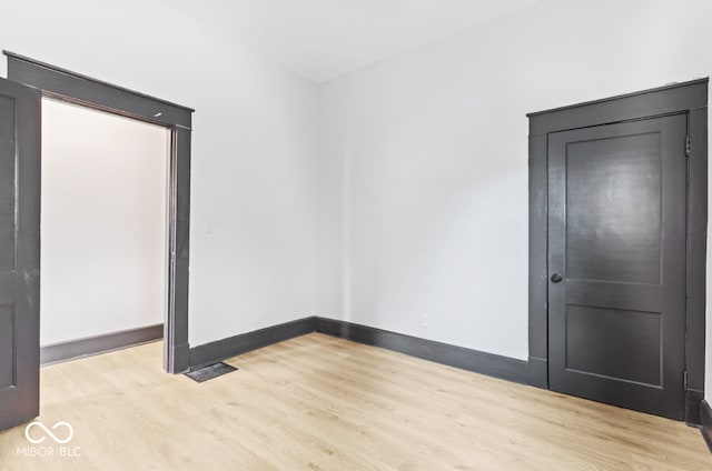 spare room with light wood-type flooring