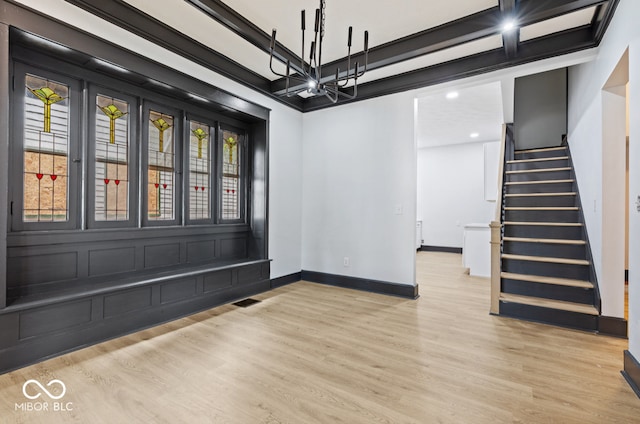 unfurnished room with an inviting chandelier and light hardwood / wood-style floors