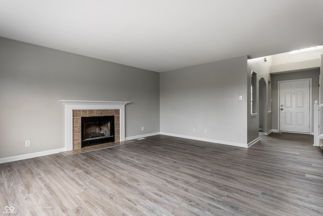 unfurnished living room with a fireplace and wood-type flooring