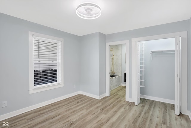 unfurnished bedroom with a closet and light hardwood / wood-style flooring