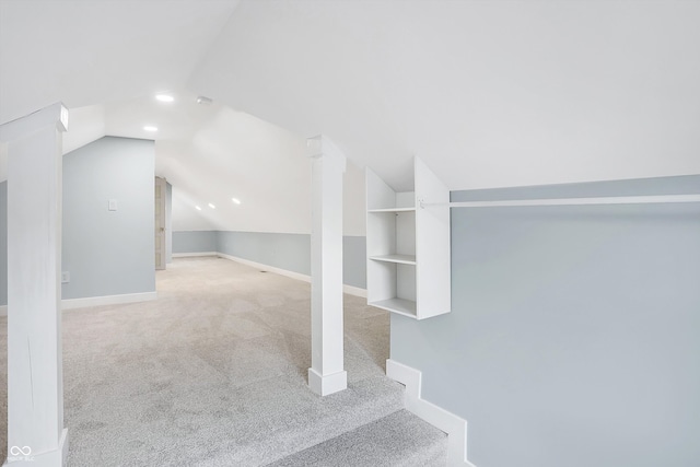 interior space with light colored carpet and vaulted ceiling