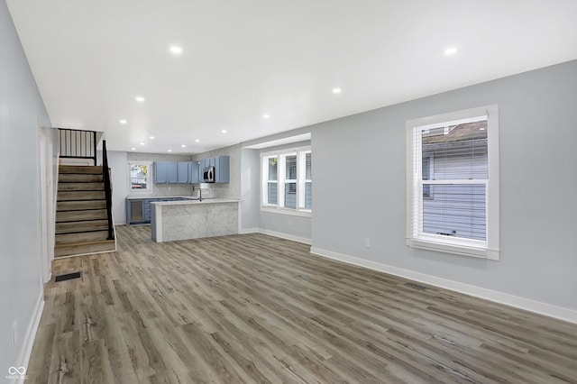 unfurnished living room with hardwood / wood-style flooring