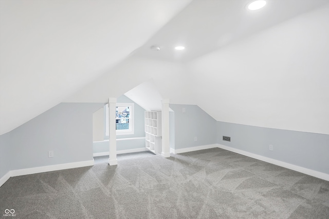 additional living space with carpet flooring and lofted ceiling