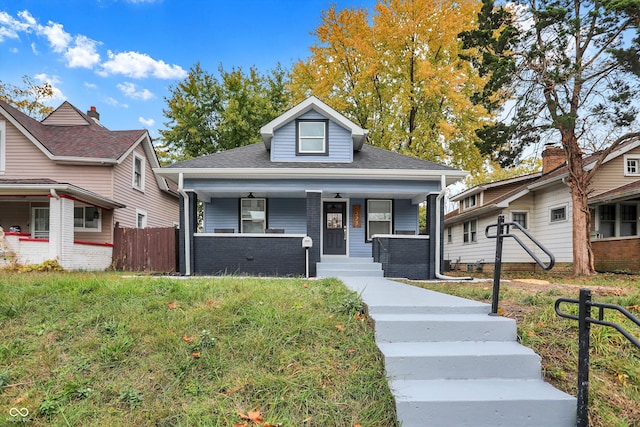 bungalow-style home with a porch and a front lawn