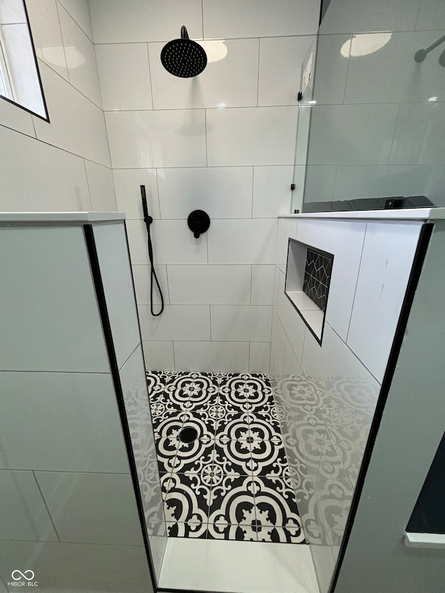 bathroom with a tile shower