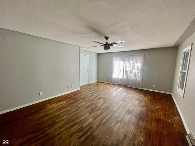 empty room featuring ceiling fan and dark hardwood / wood-style flooring