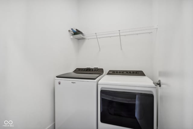 washroom with washing machine and clothes dryer