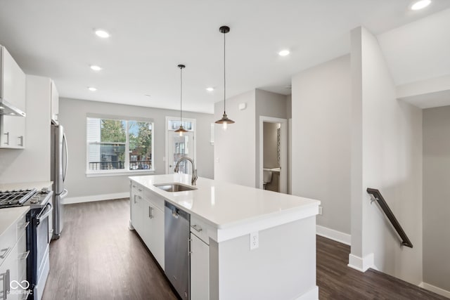 kitchen featuring a center island with sink, white cabinetry, sink, decorative light fixtures, and stainless steel appliances