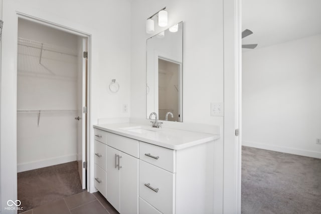 bathroom featuring vanity, ceiling fan, and tile patterned flooring