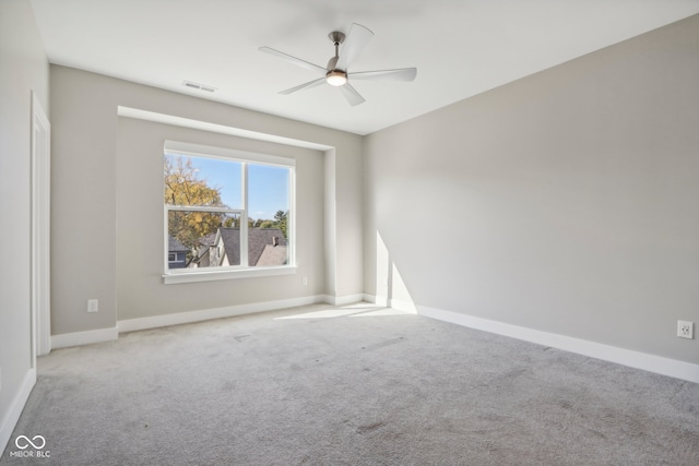 carpeted spare room with ceiling fan