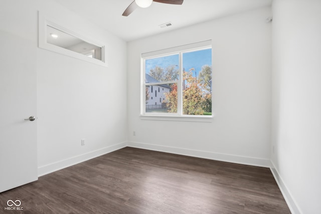 spare room featuring dark hardwood / wood-style floors and ceiling fan