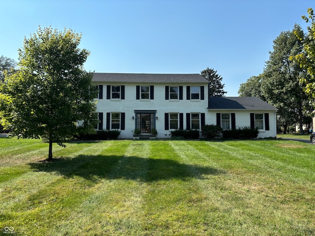 colonial inspired home with a front yard