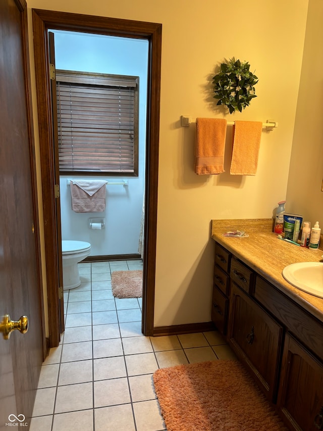 bathroom with vanity, toilet, and tile patterned floors