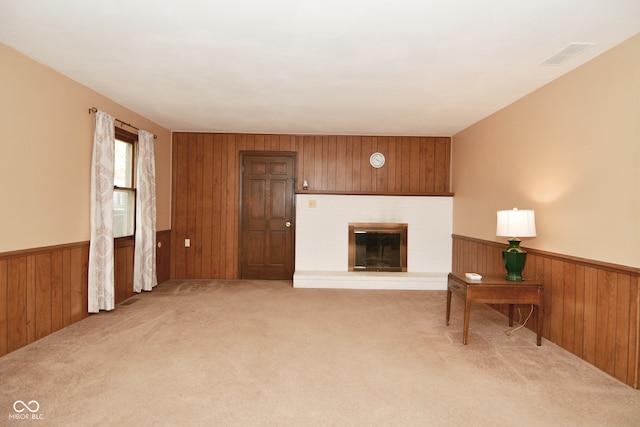 carpeted living room with wooden walls