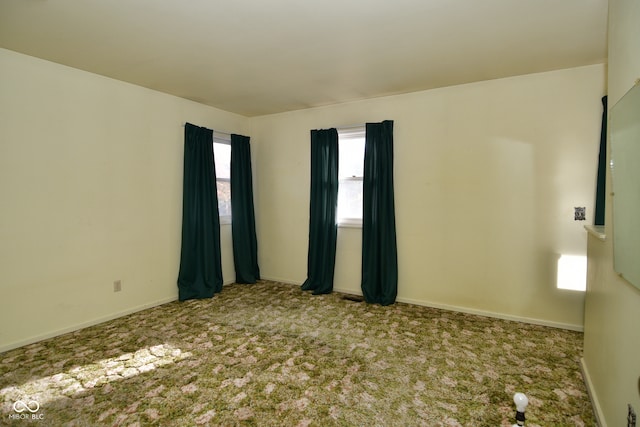 unfurnished room featuring carpet