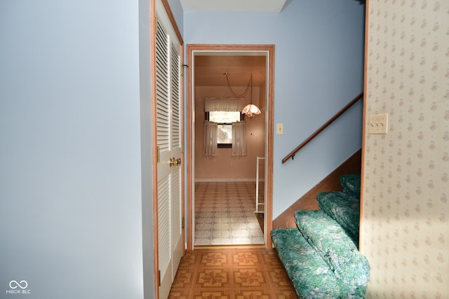 hallway with a chandelier