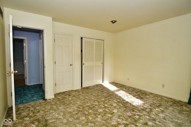 unfurnished bedroom with carpet floors and a closet