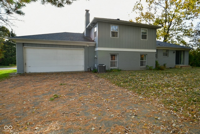 exterior space with cooling unit and a garage