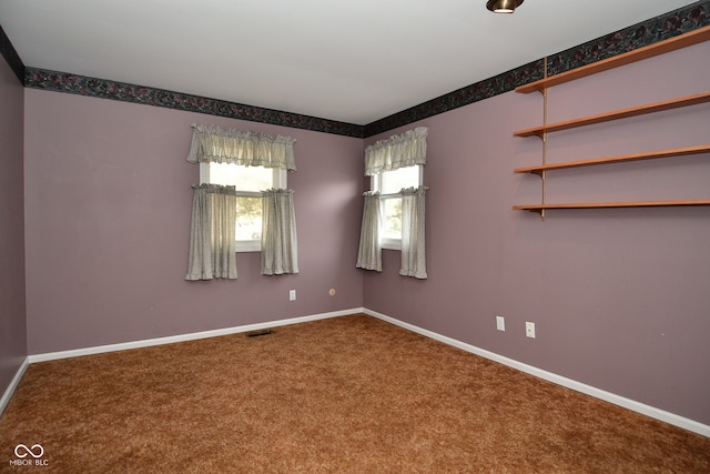 unfurnished room with carpet floors