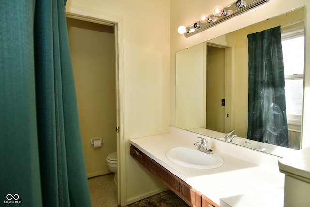 bathroom with toilet and vanity