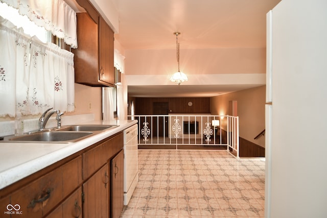 kitchen with dishwasher, sink, and hanging light fixtures