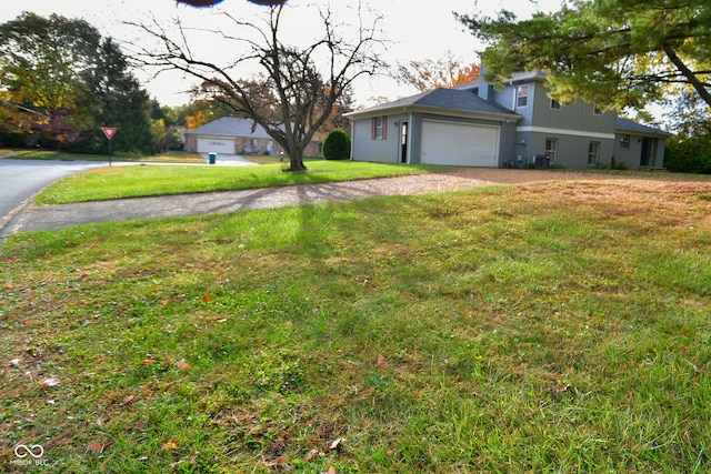 single story home with a front yard and a garage