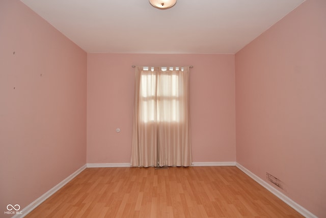 empty room with light hardwood / wood-style flooring