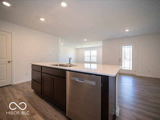 kitchen with dark hardwood / wood-style flooring, dark brown cabinetry, sink, a center island with sink, and dishwasher