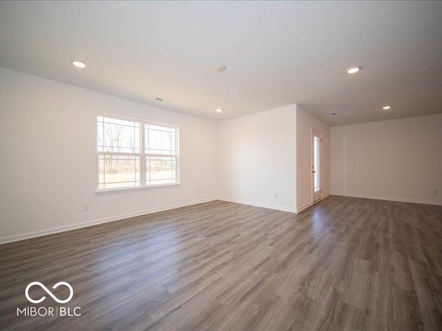 spare room with dark hardwood / wood-style flooring