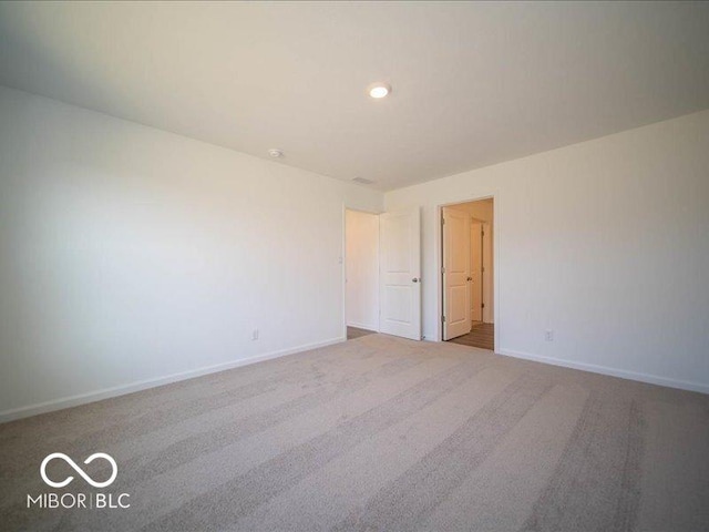 empty room featuring light colored carpet