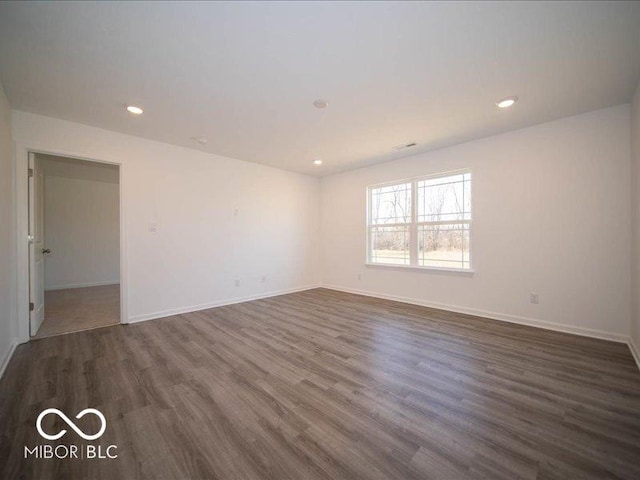 empty room with dark wood-type flooring