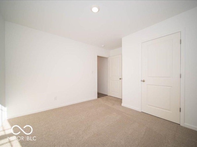 unfurnished bedroom with light colored carpet