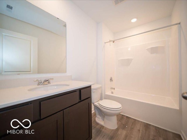 full bathroom featuring shower / bathing tub combination, hardwood / wood-style floors, vanity, and toilet