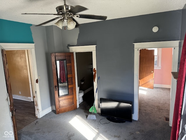 bedroom with carpet, ceiling fan, and a textured ceiling