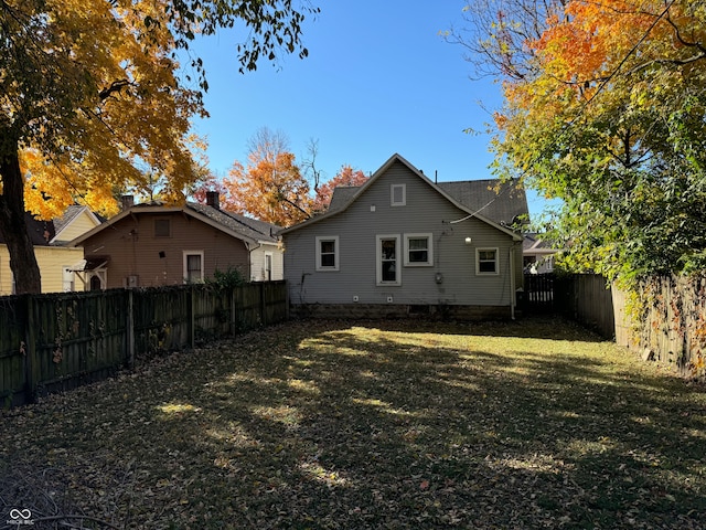 back of house with a lawn