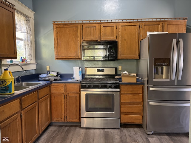 kitchen with sink, stainless steel appliances, and dark hardwood / wood-style flooring