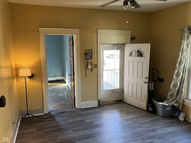 foyer entrance featuring ceiling fan, a textured ceiling, and dark hardwood / wood-style flooring