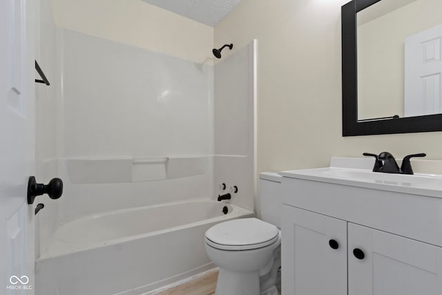 full bathroom with a textured ceiling,  shower combination, wood-type flooring, toilet, and vanity