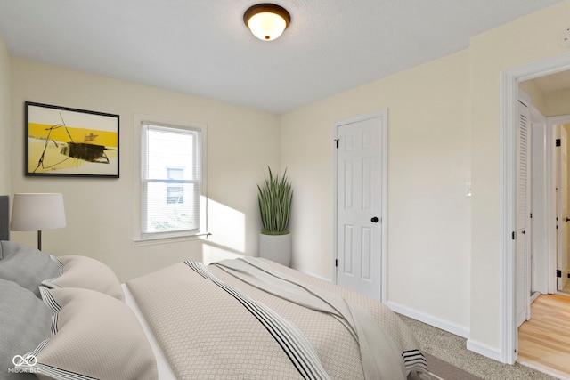 bedroom featuring light carpet