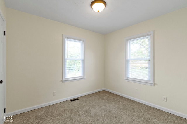 unfurnished room featuring carpet floors and plenty of natural light