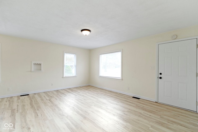 spare room with light hardwood / wood-style floors