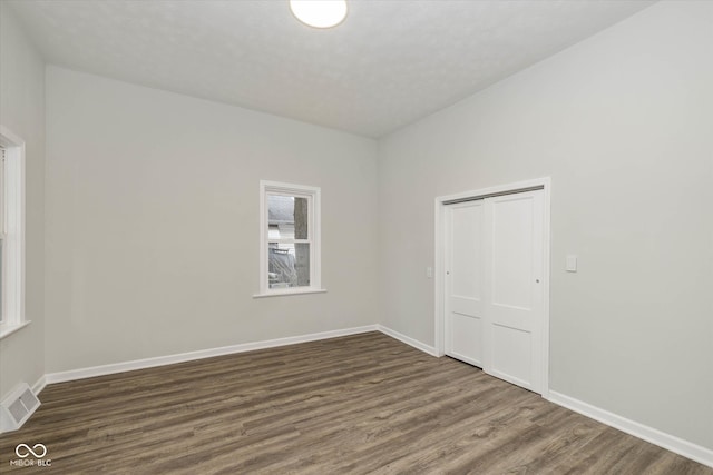 spare room featuring dark wood-type flooring