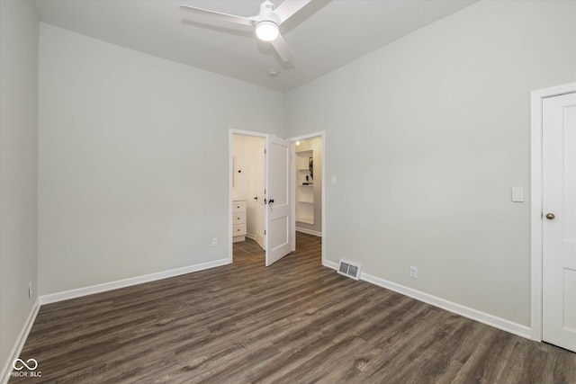 unfurnished bedroom featuring ceiling fan and dark hardwood / wood-style floors