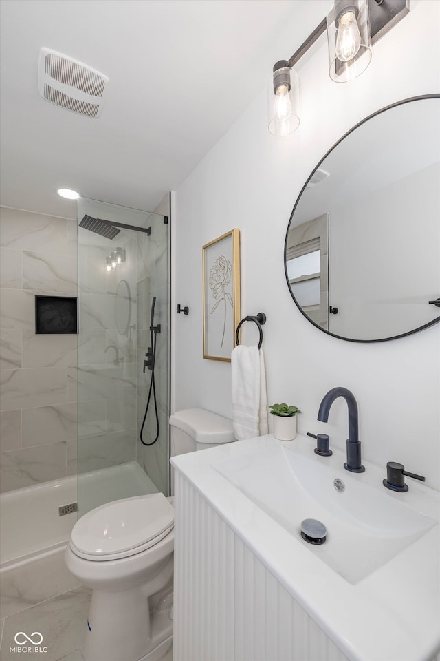 bathroom featuring toilet, sink, and a tile shower