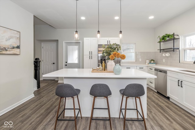 kitchen with dishwasher, white cabinetry, and dark hardwood / wood-style floors