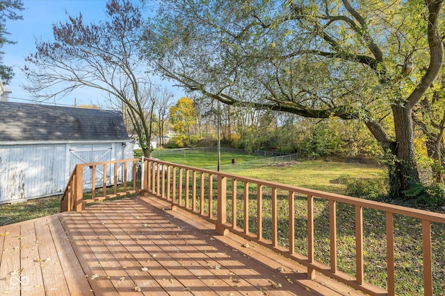 wooden deck featuring a lawn